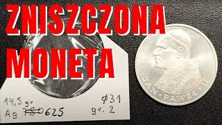 Srebrna moneta uszkodzona przez holder - co jest przyczyną???