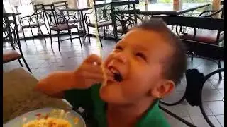 Tommy eating long spaghetti strand