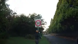 Moto rider cleans speed limit sign