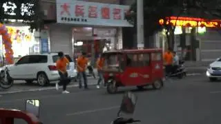 Dancing marketing around mobile phone shop. Central China (Anhui province, 2017).