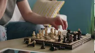 wooden chess board man is playing chess ATYL837